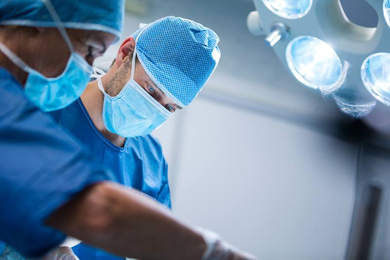 Surgeons performing operation in operation room at the hospital